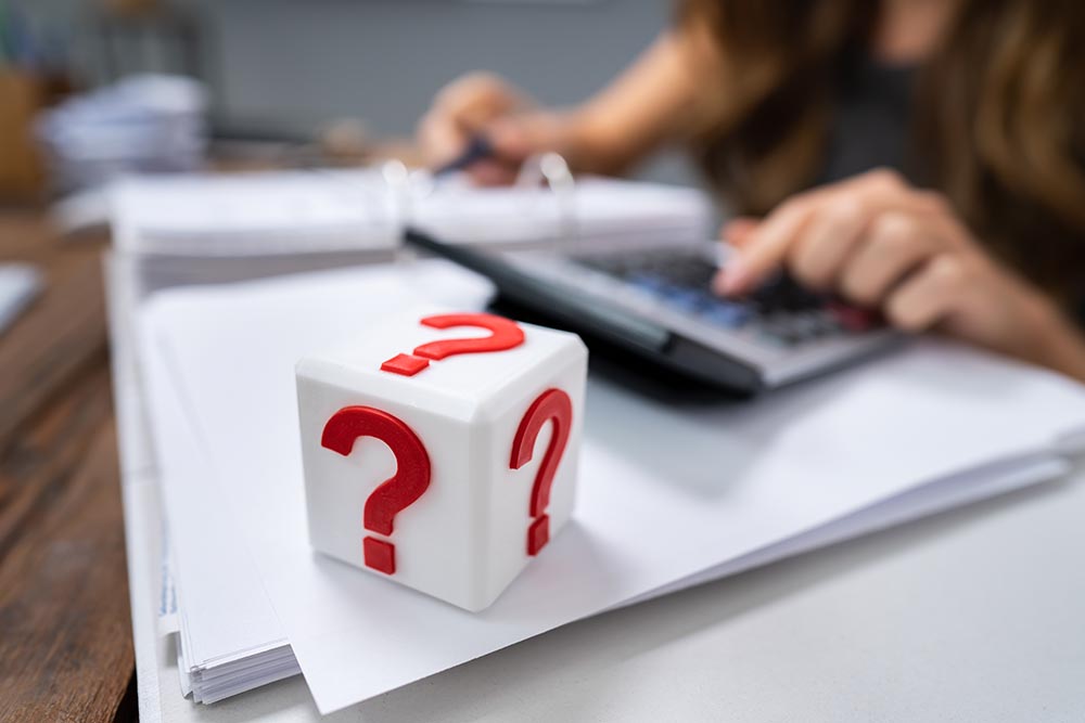 Cubic Block With Red Question Mark Sign On Desk